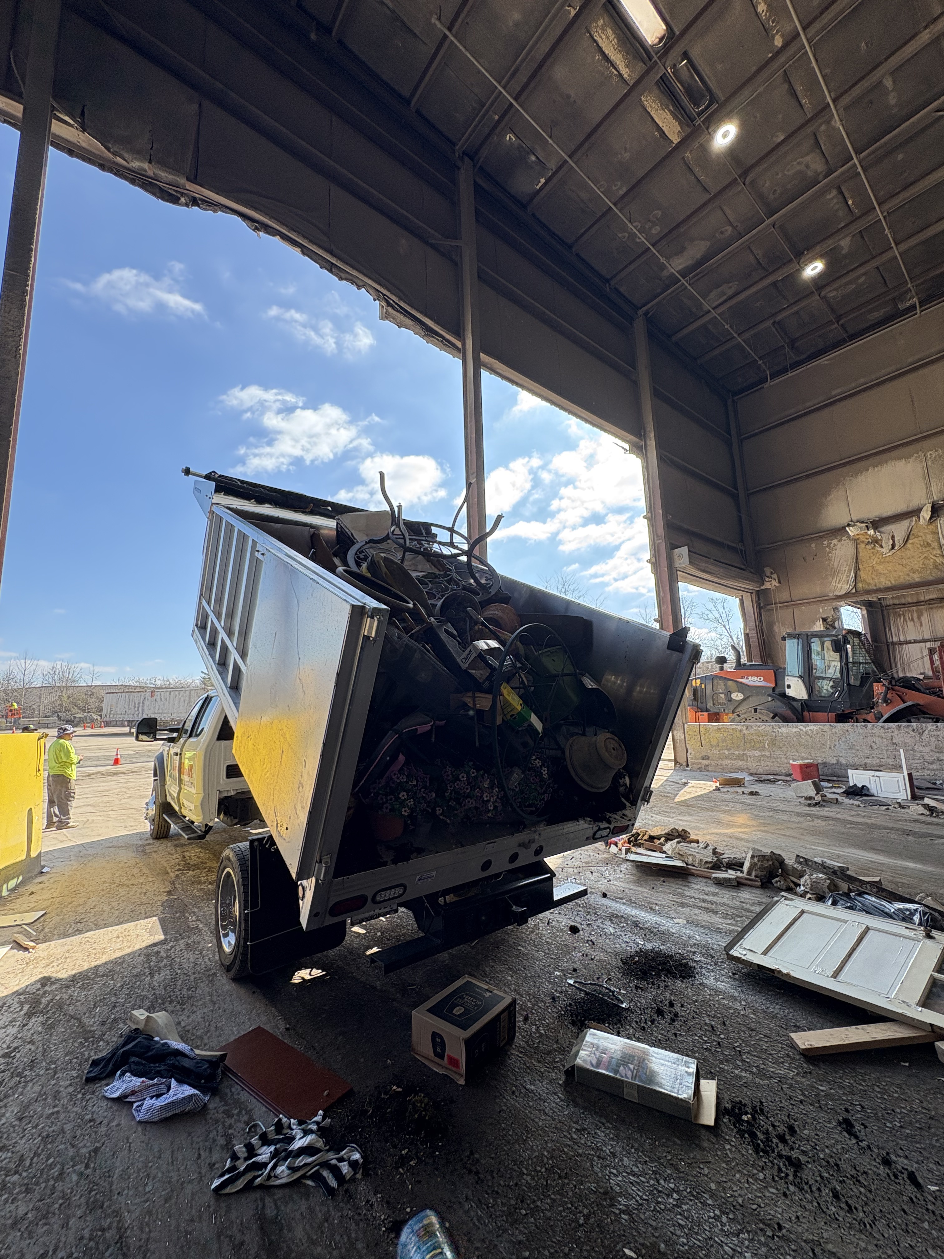 Larson Landscape dump truck fully loaded with a junk removal haul at the transfer station