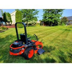 Zero-turn mower on a freshly striped lawn