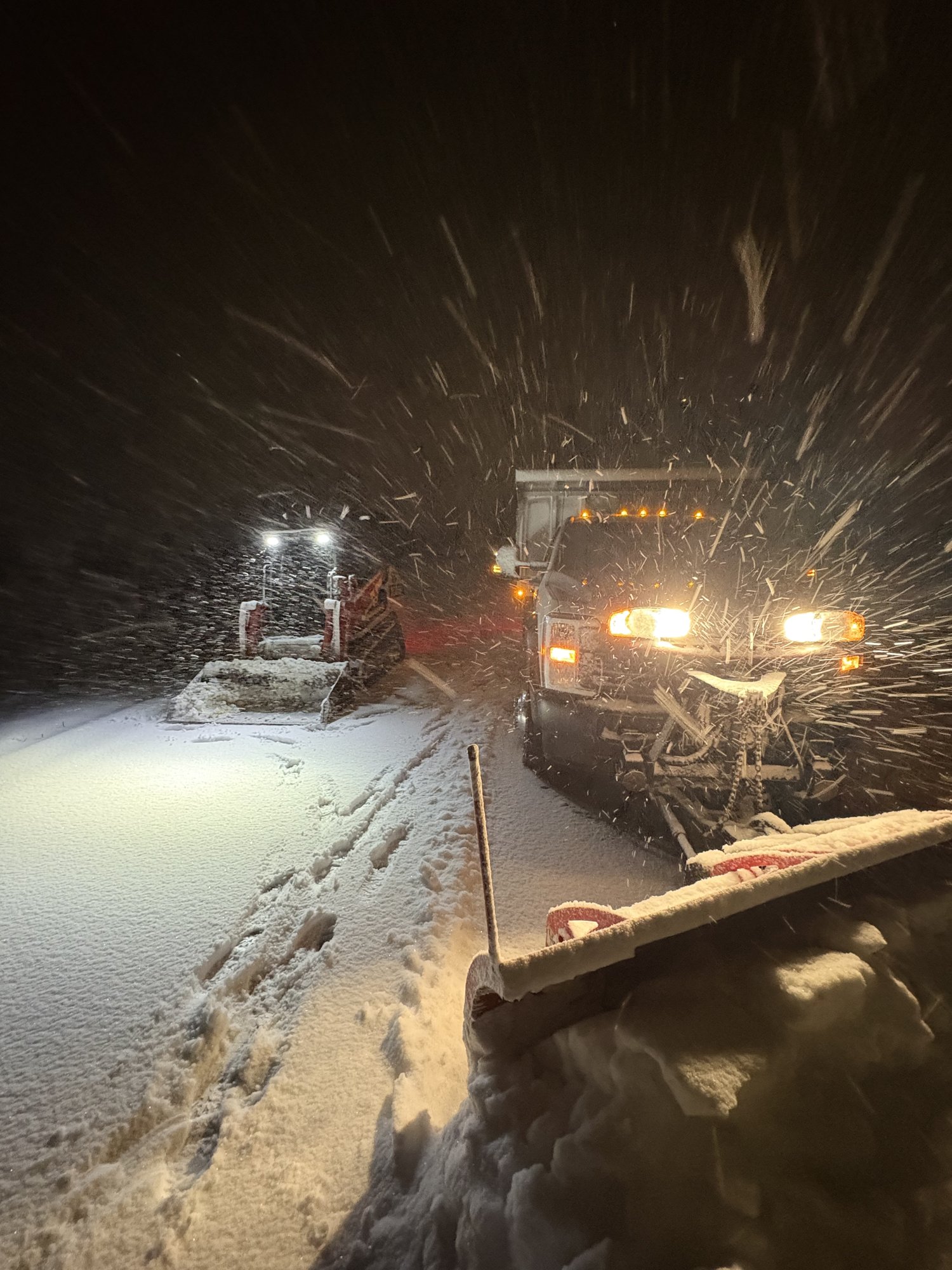 Larson Landscape plow truck and skid steer working overnight during a heavy snowstorm