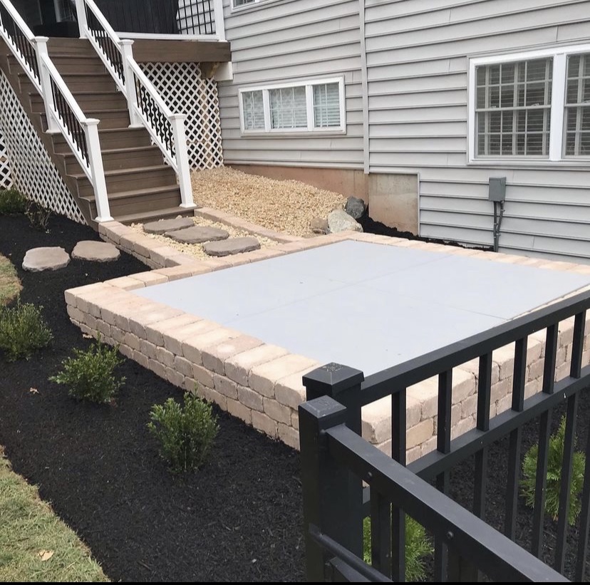 Raised patio with retaining wall and clean planting beds